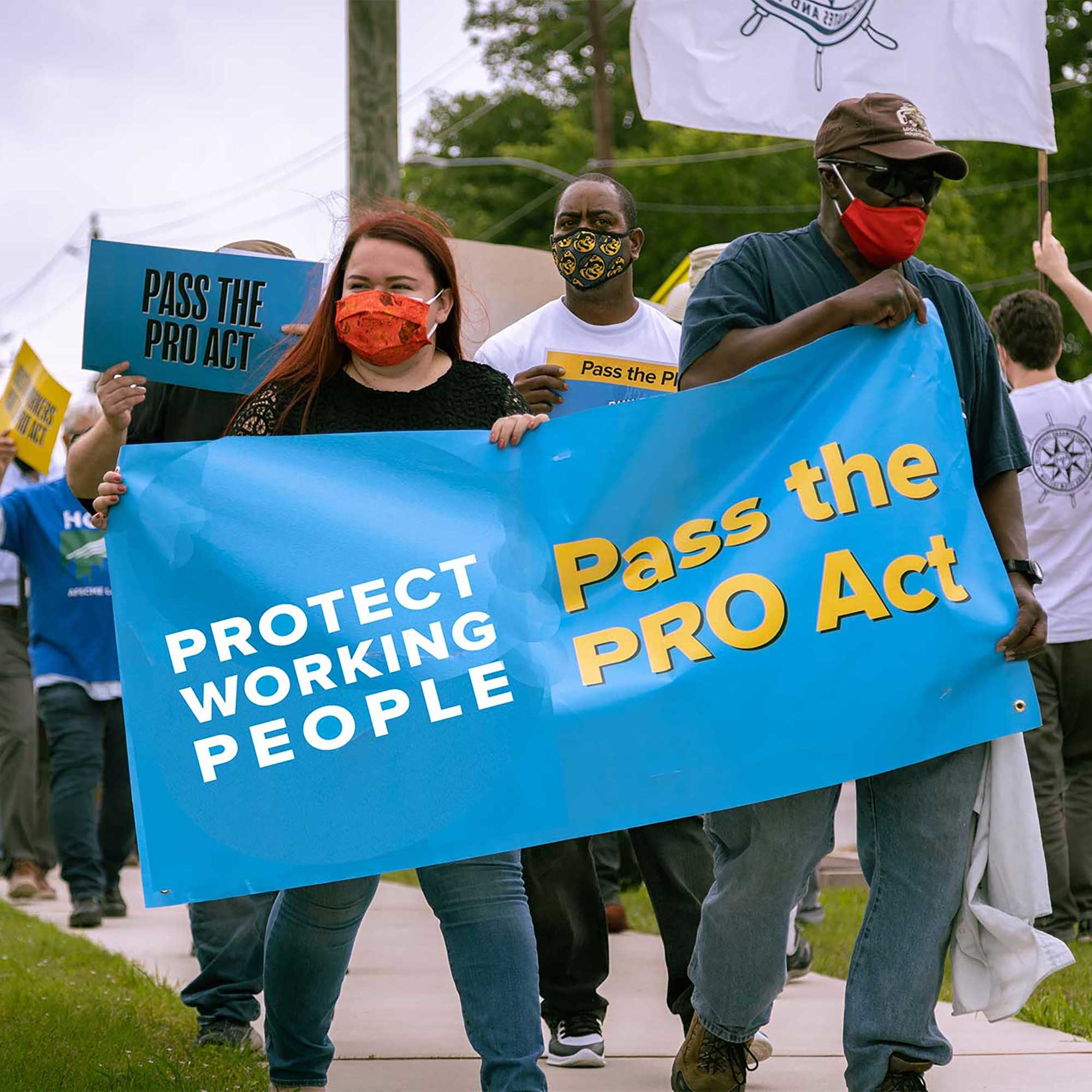Protesters holding a Pass the PRO Act banner